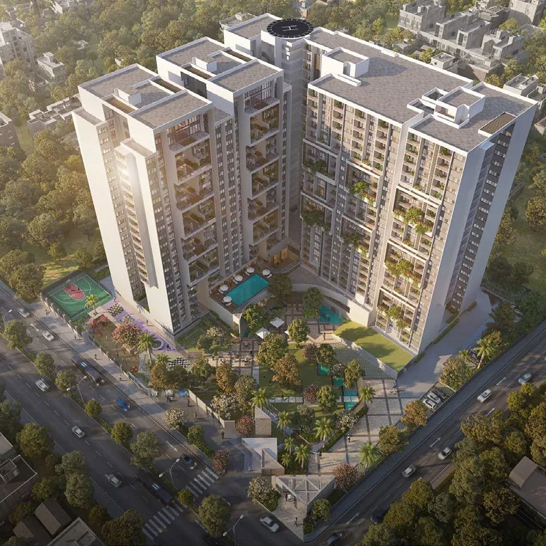 An aerial view of the towers, pool deck and courts of ELV HighGarden among trees