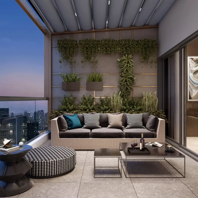 A furnished balcony with a green wall looking over the city lights at ELV HighGarden
